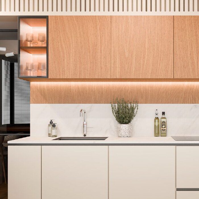 Close-up of wood cabinetry, marble backsplash and glass shelving in the Quiet Lines kitchen