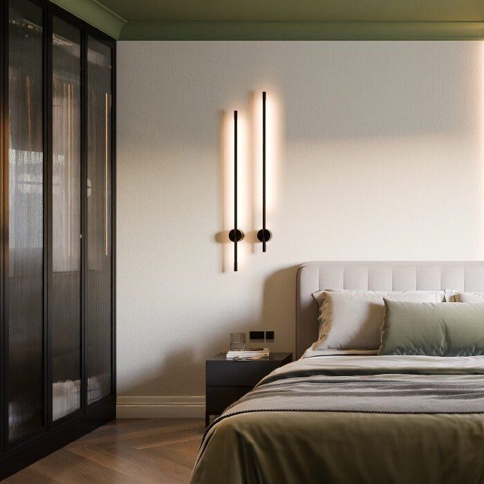 Close-up of vertical wall sconces above the bed in the Parisian Apartment master bedroom